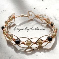 a bracelet with gold and black beads on it