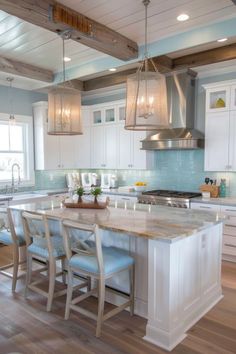 a large kitchen with an island in the middle and several chairs at the counter top