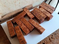 several pieces of wood sitting on top of a cutting board