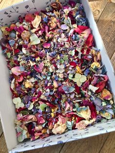 a box filled with lots of different colored flowers