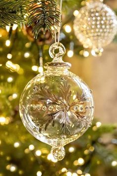 a glass ornament hanging from a christmas tree