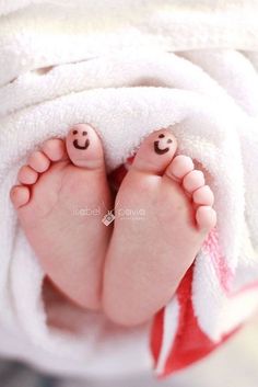 a baby's feet are wrapped in a towel