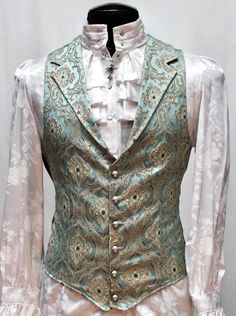 Note: These vests are very fitted. Check the size measurements below very carefully to find the size that will fit you best. A Victorian gentleman's vest with class. Great for formal occasions, can be worn under a suit jacket or by itself. Made in rich green brocade fabric with an intricate antique design on it with gold thread. With black satin lining inside and on the back. This vest has a very flattering tapered fit and ties in back with satin belting so it can be made tighter in the waist. Fastens in front with six metal buttons. A notched collar adds extra style. Comes in sizes Small-3X. Smoooth! Size Small = chest 39" midsection 36" waist 36" Size Medium = chest 42" midsection 38" waist 38" Size Large = chest 45" midsection 40" waist 40" Size XL = chest 48" midsection 43" waist 43" S Fairy Suits For Men, Fancy Green Outfits Men, Fantasy Tuxedo Male, Victorian Vest Mens, Enchanted Forest Suit For Men, Enchanted Garden Prom Suit, Fancy Suits Men, Green Prince Aesthetic, Elven Wedding Suit Men