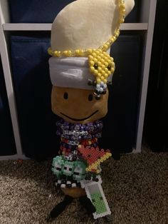 a toy made to look like a nutcracker with beads on it's head