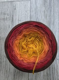 a skein of yarn sitting on top of a wooden table