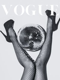 a woman in fishnet stockings holding a disco ball