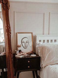 a bedroom with a mirror, dresser and bed