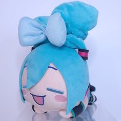 a blue stuffed animal with a big bow on its head