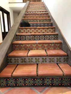 a set of stairs with decorative tiles on them