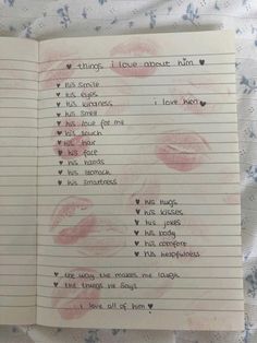 an open notebook with writing on it and pink lipstick drawn on the pages in different languages