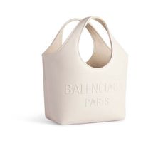 Mary-Kate Xs Tote Bag In Off White / Ivory Soft Smooth Calfskin, Aged-Silver Hardware Product Details Dimensions: L9,4 X H9,4 X W4,3 Inch Handle Drop: 5,1 Inch Soft Smooth Calfskin Tote Bag Two Handles High Frequency Embossed Balenciaga Paris Logo At Front Aged-Silver Hardware Open Top 1 Inner Zipped Pocket Suede-Like Fabric Lining Made In Italy Wipe With A Soft Cloth Material: 100% Calfskin Luxury Cream Bags With Logo, Chic Cream Bags With Logo, Designer Cream Shoulder Bag With Logo, Logo Bucket Shoulder Bag For Everyday Use, Everyday Bucket Shoulder Bag With Logo, Cream Logo Bag For Daily Use, Everyday Bucket Bag With Logo, Everyday Bucket Bags With Logo, Everyday Use Bucket Bags With Logo