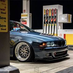 a silver car parked in front of a gas station