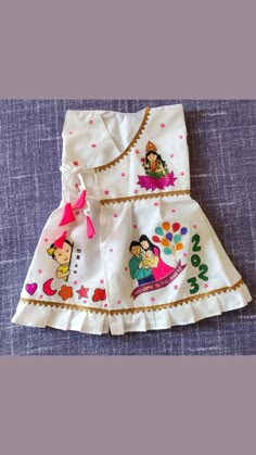 a white dress with cartoon characters on it