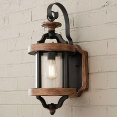 Vineyard chic best describes the unique look of this outdoor lighting collection. Traditional elements are paired to create a lovely design using a cage-like textured black frame with the look of wrought iron and contrasting painted wood bands in a whiskey barrel inspired finish. Rustic Hallway Lighting, Exterior Porch Lights, Exterior Wall Light Fixtures, Farmhouse Outdoor Lighting, Barndo Ideas, Outdoor Garage Lights, Rustic Outdoor Lighting, Industrial Exterior, Porch Light Fixtures