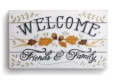 a wooden sign that says welcome friends and family with acorns on the front