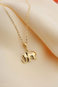 14k Solid Gold Elephant Necklace, Good Luck Charm Necklace, Dainty Gold Pendant, Animal Necklace, Minimalist, Gift for Her, Everyday Jewelry This solid gold dainty Necklace is made entirely from 14k solid gold. * Jewelry is packaged and shipped in a delicate jewelry gift box. * If you are purchasing it as a gift, please feel free to add a personal note. Anniversary, Gift For Wife, Christmas Gift Gold Kt: 14K solid gold * Guaranteed Authentic 14k Gold, NOT Plated Or Filled * Stamp: 14K Elephant Locket Gold, Elephant Pendant Gold, Dainty Necklaces Gold, Fish Pendant Gold, Minimalist Accessories Jewellery, Gold Elephant Pendant, Elephant Necklace Gold, Gold Pendants For Men, Bridal Foot Jewelry