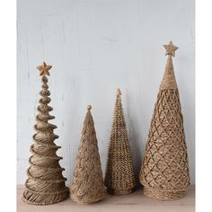 three small christmas trees made out of jute and twine with stars on top