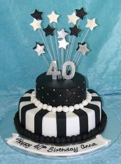 a black and white birthday cake with stars on the top that says forty an birthday one