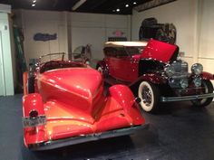 an antique car is on display in a museum