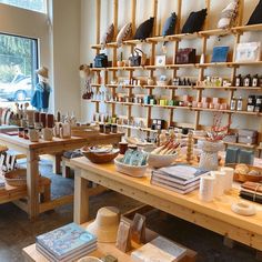 a store with wooden tables and shelves filled with items