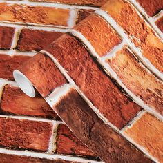 a brick wall with a white light on the top and some brown bricks around it