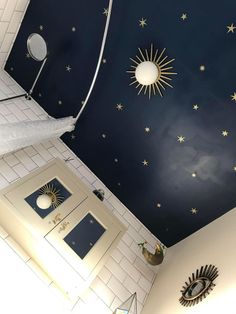 a bathroom with stars painted on the ceiling