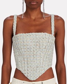 A luxe update to corsetry the L.A. label tailors its bustier top from a delightful bouclé-tweed for a cool party-ready finish. Add a touch of sparkle with dazzling drop earrings.   Fabric: 42% cotton, 29% polyamide, 12% wool, 8% acrylic, 7% viscose, 2% polyester.  Lining: 100% viscose.   Concealed back zip closure.   Dry clean.   Imported.       Length from shoulder to hem: 18".   Model is wearing size FR 36.  Model height 5'10", bust 33", waist 24.5”, hips 34.5”.      Item is listed in French s Elegant Cropped Corset With Fitted Bodice, Elegant Cropped Corset With Boned Bodice, Elegant Cropped Evening Corset, Elegant Cropped Corset For Evening, Cropped Corset With Fitted Bodice For Parties, Party Cropped Corset With Boned Bodice, Cropped Party Corset With Boned Bodice, Elegant Cropped Corset For Parties, Earrings Fabric