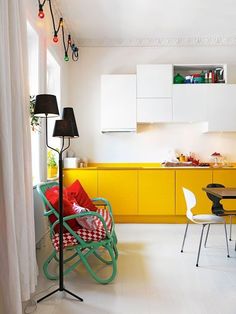 a kitchen with yellow cabinets and white floors