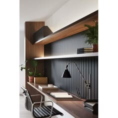 an office with black and white walls, wooden shelves and a chair in the foreground