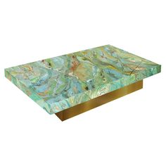 a green and gold marble coffee table with metal base on white background, side view