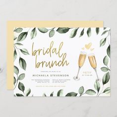 the bridal brunch wedding card is shown with two champagne glasses and greenery