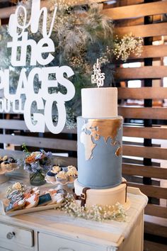 a cake sitting on top of a white table next to a sign that says save the places with go