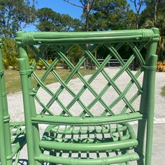 a green chair sitting on top of a cement ground