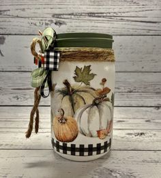 a mason jar decorated with pumpkins and leaves