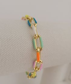 These gorgeous gold and enamel link bracelet are high quality 18k gold plated over copper. Each colorful link measures 7x13 mm. Bracelet length is customizable when ordering (6-9 inches) and have a lobster clasp closure. ▪️These multicolor, chain bracelets are fun and trendy and great for summer. They have a casual, yet high end vibe and are beautiful when worn alone or stacked & layered with your other favorite pieces. Please see my other listings below for matching necklace and earrings ♦️ Ple Multicolor Chain Bracelets As Gift, Multicolor Adjustable Chain Bracelet, Multicolor Chain Bracelet Jewelry, Multicolor Metal Chain Bracelet, Trendy Summer Jewelry, Gold Enamel Bracelets With Adjustable Chain, Gold-tone Metal Link Bracelet, Gold-tone Link Charm Bracelet, Gold-tone Chain Link Charm Bracelet