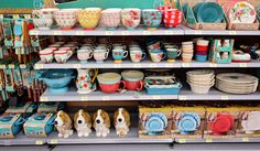 the shelves are filled with colorful dishes and bowls for sale at the store's booth