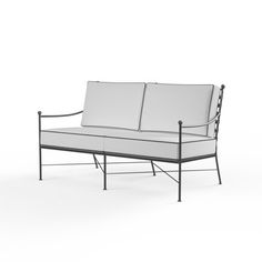 a white couch sitting on top of a metal frame