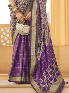 the grey and purple color silk saree with floral print work and zari weaving border. This saree beautifully blends vibrant hues with intricate craftsmanship, making it an ideal choice for weddings, festivals, and other special occasions. The combination of elegant grey and regal purple creates a striking visual appeal, while the delicate floral prints add a touch of femininity and grace to the ensemble.
The saree's standout feature is its intricate zari weaving border work. The luxurious gold-to Wedding Purple Saree With Printed Border, Luxury Purple Chanderi Pre-draped Saree, Festive Purple Silk Pre-draped Saree, Purple Floral Embroidered Semi-stitched Saree, Elegant Purple Pre-draped Saree In Tussar Silk, Wedding Wear Saree, Engagement Gown, Lehenga Crop Top, Lehenga Choli Wedding