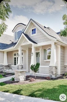 a house with white trim and gray shingles