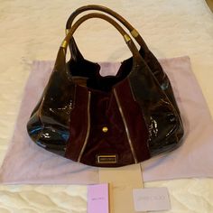 Jimmy Choo Mandah Hobo Style Handbag Has A Zipper To Make Larger Or Smaller The Color Is A Burgundy/ Brown With Gold Hardware Has Two Interior Side Pockets One Small Exterior Pocket Very Good Condition Worn A Few Times Original Dust Bag Authenticity Card And Receipt Jimmy Choo Bags, Jimmy Choo Bag, Hobo Style, Hobo Bag, Jimmy Choo, Gold Hardware, Dust Bag, Bag Lady, Exterior