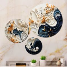 three circular artwork pieces on a marble wall