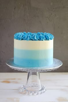 a blue and white cake sitting on top of a glass plate