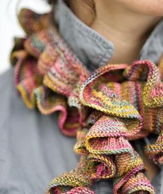 a close up of a woman wearing a scarf with ruffles on her neck