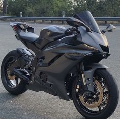 a black motorcycle parked in front of a building