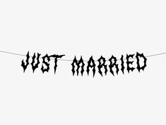 a black and white photo of the word just married hanging from a line with bats