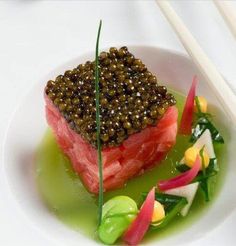 a white plate topped with food and chopsticks