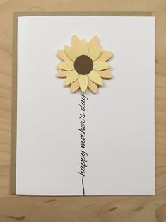 a white card with a yellow flower on it