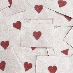 lots of small red hearts on white envelopes