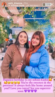 two women standing next to each other in front of a sign that says happy birthday