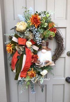 a wreath on the front door is decorated with flowers and an gnome's head